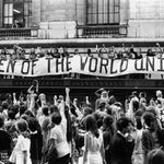 To commemorate the fiftieth anniversary of women’s suffrage in the United States, an estimated twenty thousand women march along Fifth Ave., here past a banner that reads, ‘‘Women of the World Unite!”, August 26, 1970<br/>